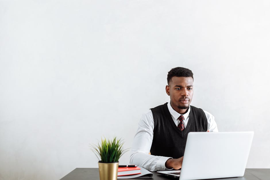 brazilian entrepreneur using laptop in a modern office