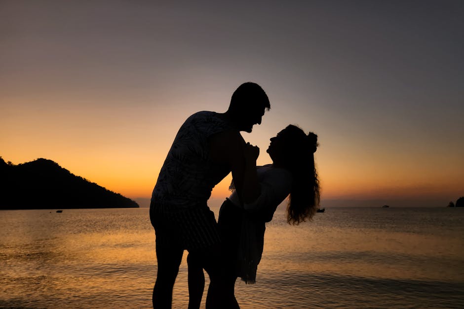 Couple enjoying beach at sunset