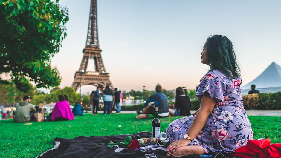 couple having picnic by eiffel tower
