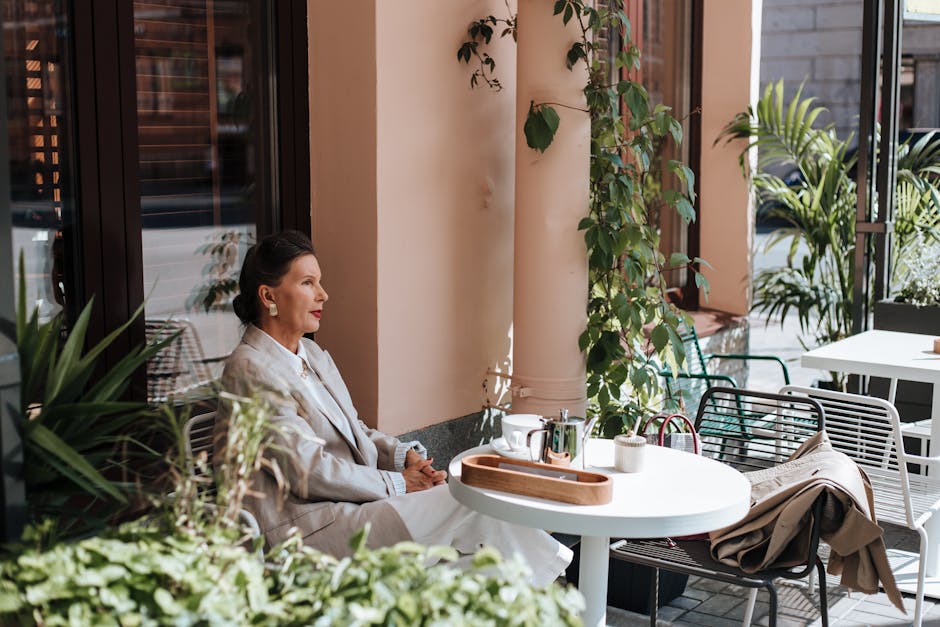elegant woman having coffee on summer terrace in nice