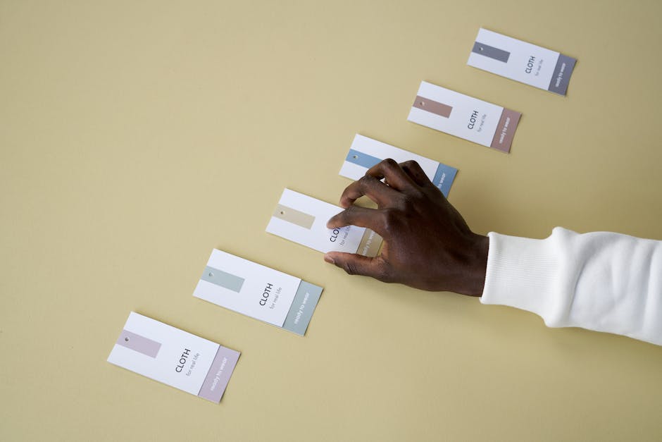 man comparing clothing tags for quality and material