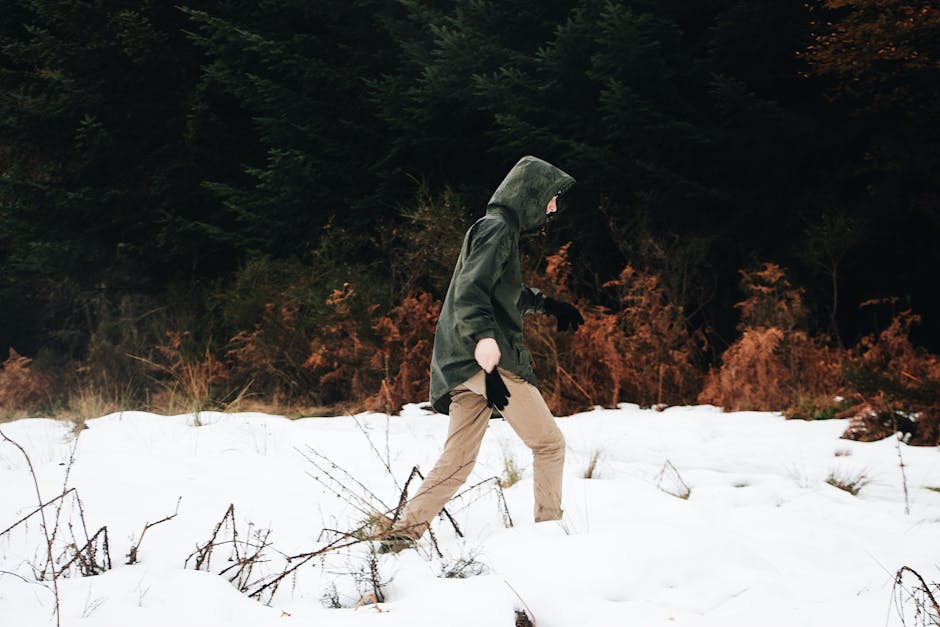 man walking in snow with elegant coat
