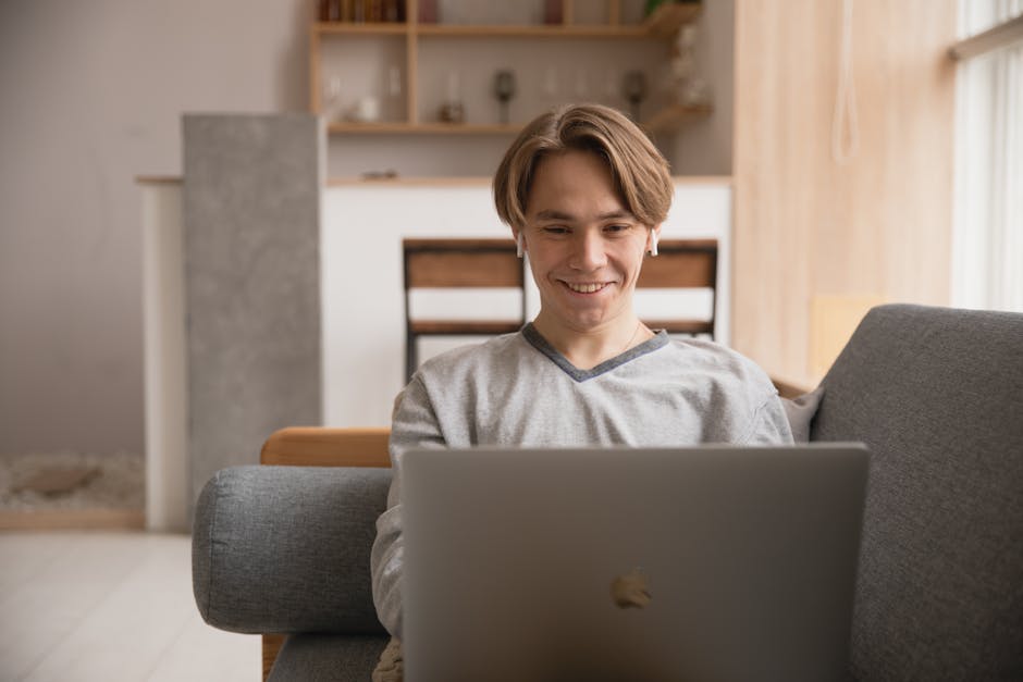 person happily working on laptop