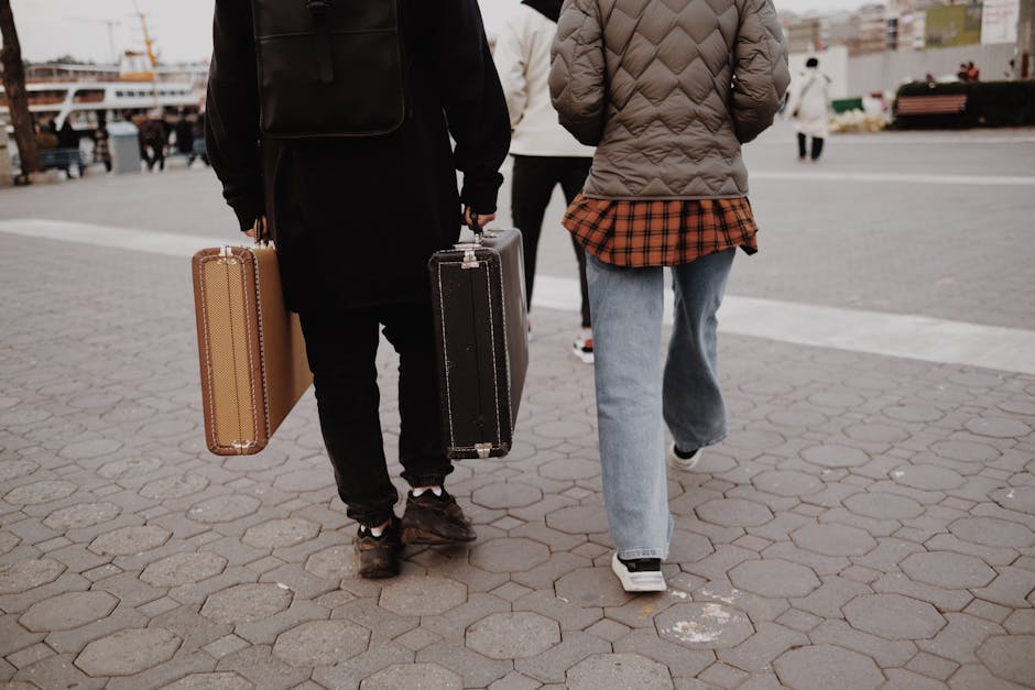 Traveler walking with small suitcase and backpack