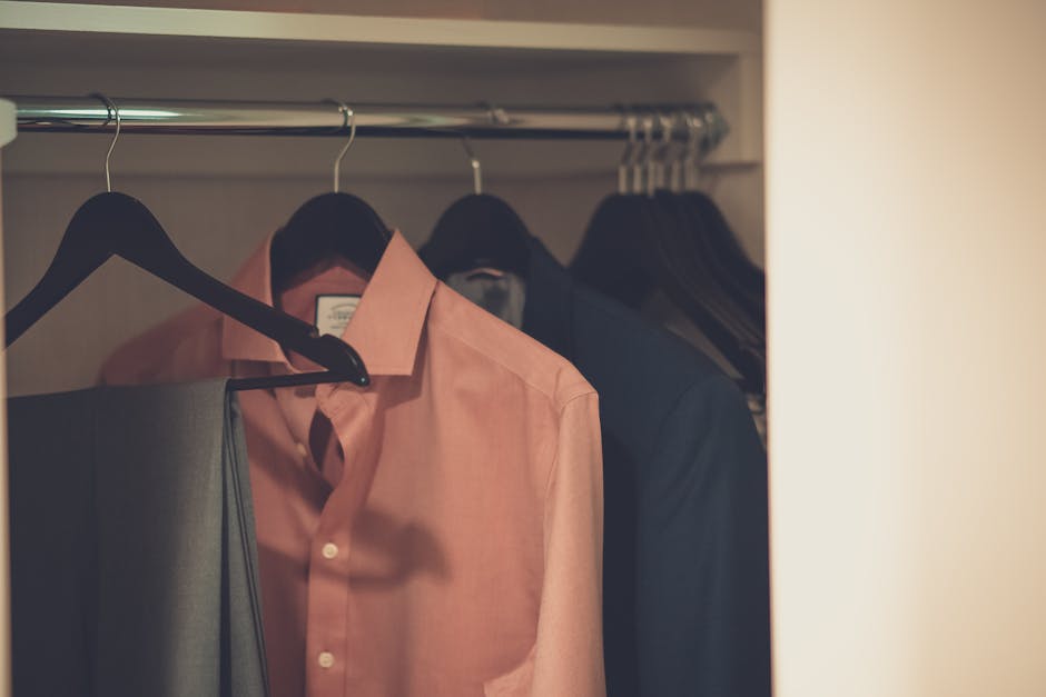 wardrobe with neatly organized neutral clothing for men