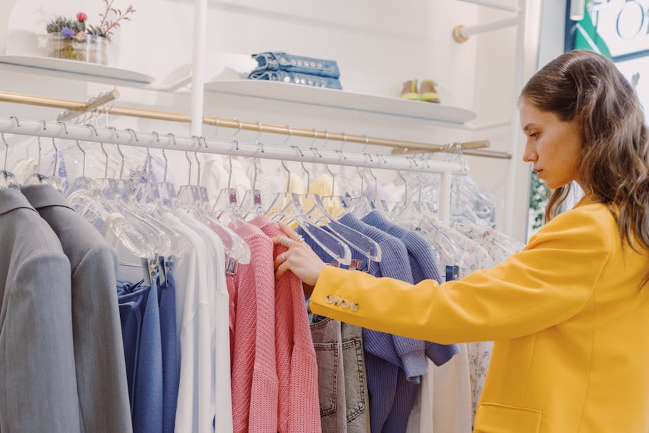 woman choosing clothes in stylish boutique