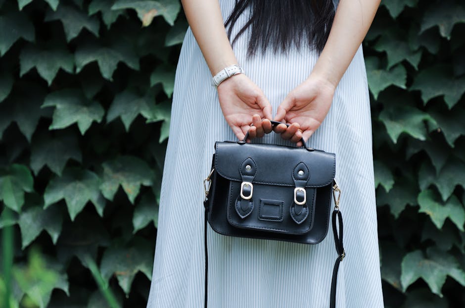 woman holding elegant leather handbag