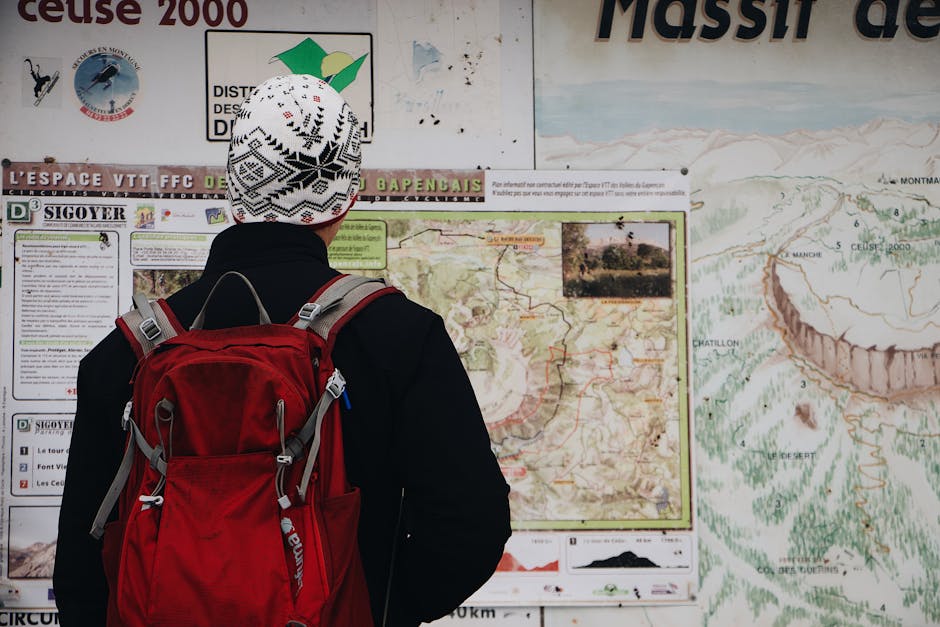 woman looking at map with small backpack in French village