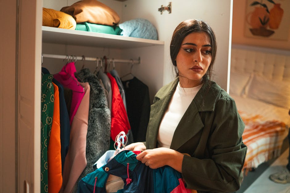 woman sorting clothes in closet