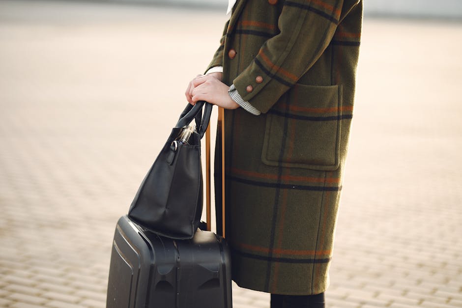 woman standing with small luggage in French street