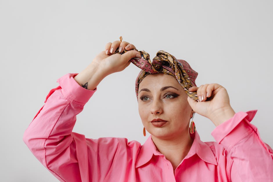 woman tying a silk scarf around her neck