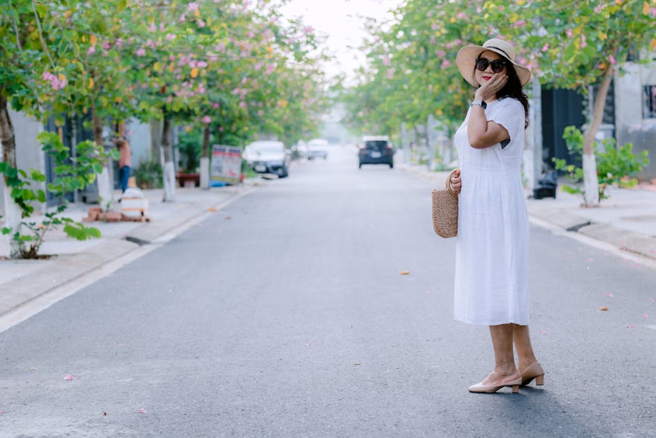 woman wearing light flowing dress in sunny street