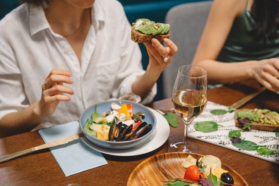 A vibrant table spread with various easy vegetarian dinner ideas, including pasta, a large salad, and roasted vegetables, enjoyed by a family.