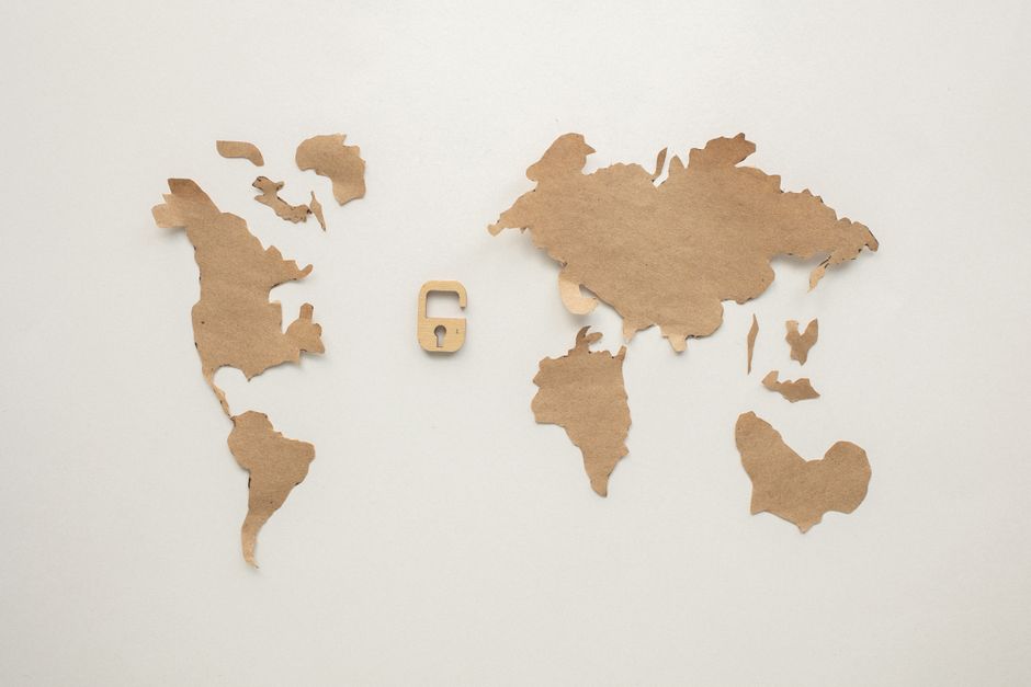 A digital padlock icon superimposed over a blurred world map with connecting lines, symbolizing global VPN security and privacy.