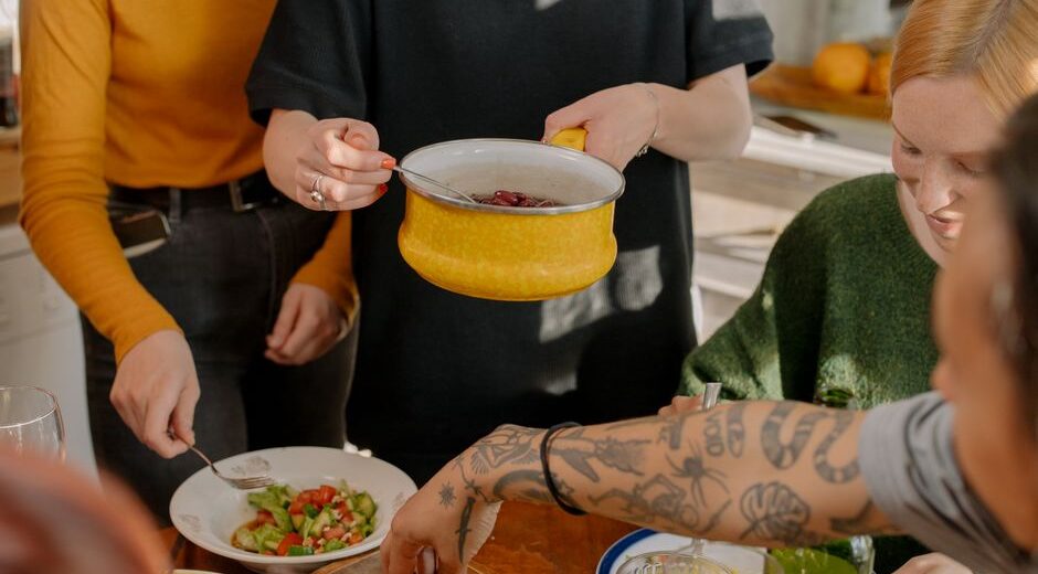 A family happily cooking a vegetarian stir-fry together in a brightly lit kitchen.