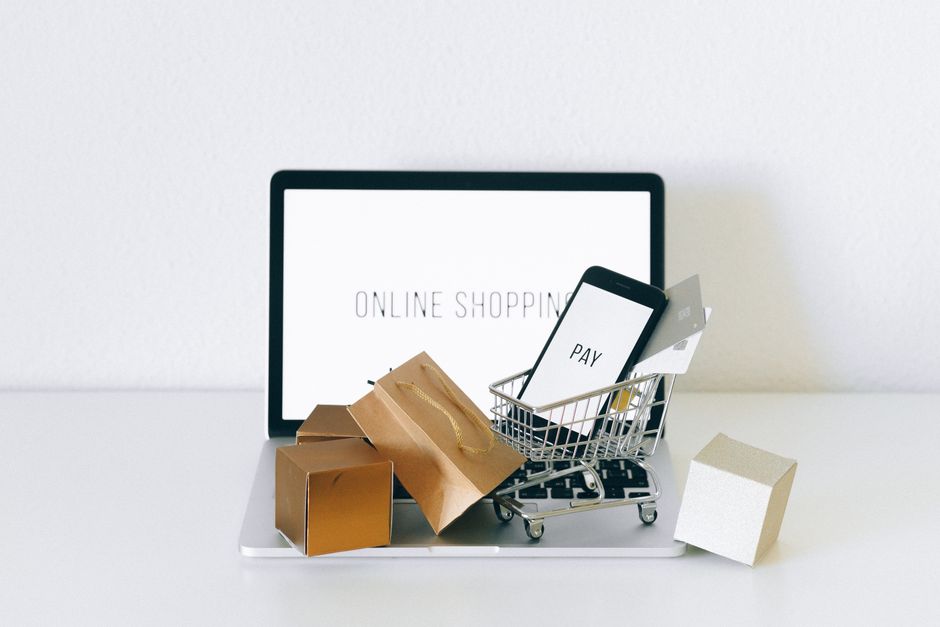 A stylized globe with a shopping cart icon overlayed, representing global e-commerce and the international nature of online shopping, surrounded by digital currency symbols.