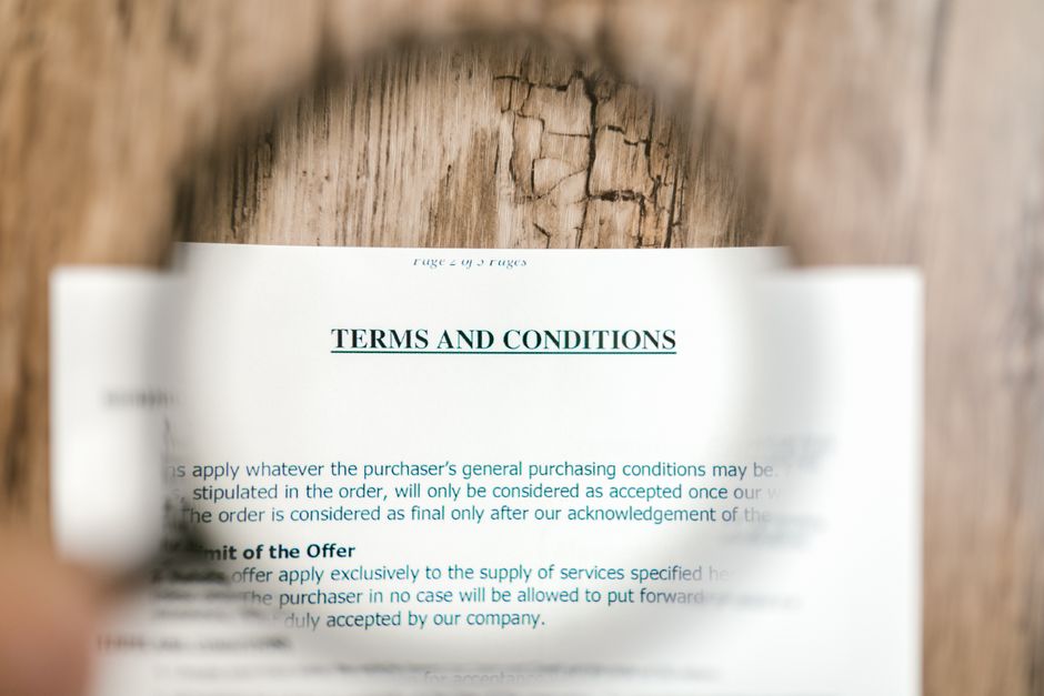 A close-up of a magnifying glass highlighting specific text within a dense legal document, symbolizing the scrutiny of a VPN privacy policy.