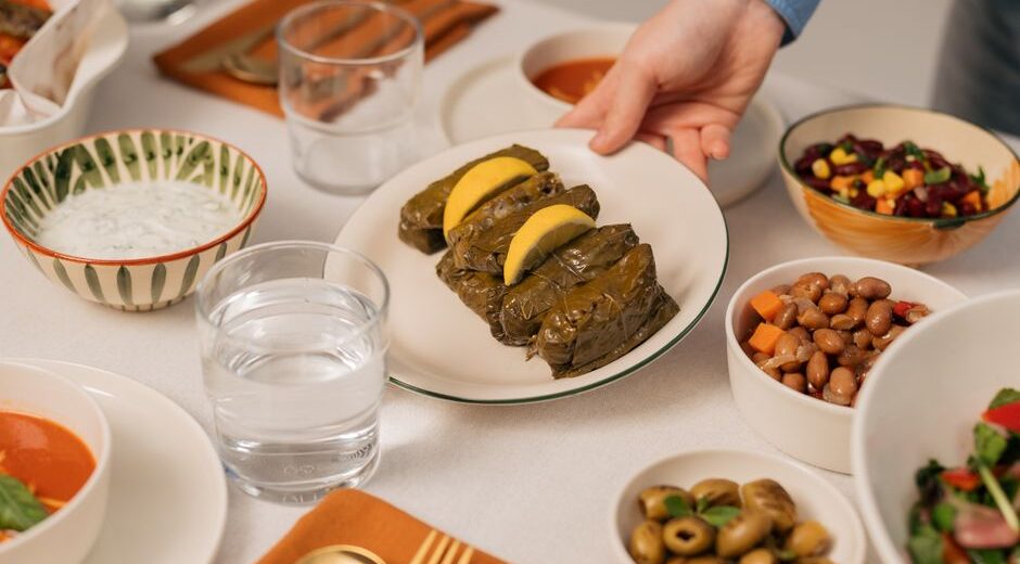 A family enjoying a healthy, home-cooked Mediterranean meal at a kitchen table, showcasing fresh ingredients and shared experience.