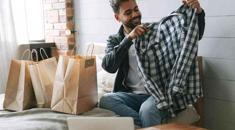 A man thoughtfully examining the fabric of a sustainable shirt, symbolizing conscious fashion choices.