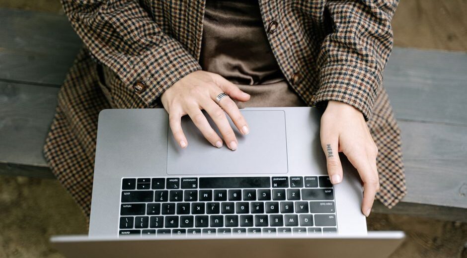 A close-up shot of a hand pointing at a laptop screen showing a padlock icon in the browser's address bar, signifying a secure website.