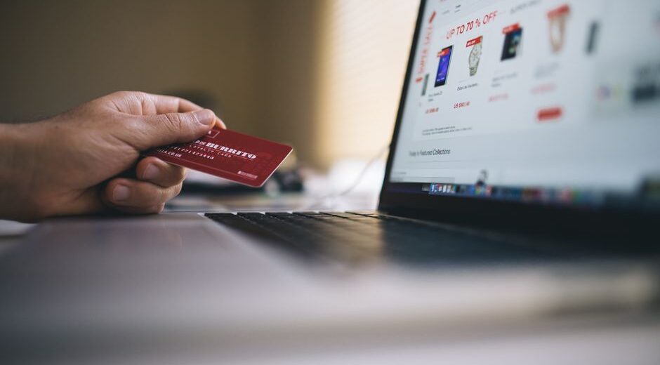 A person using a laptop, checking the HTTPS padlock icon in a web browser, indicating a secure connection for online shopping.
