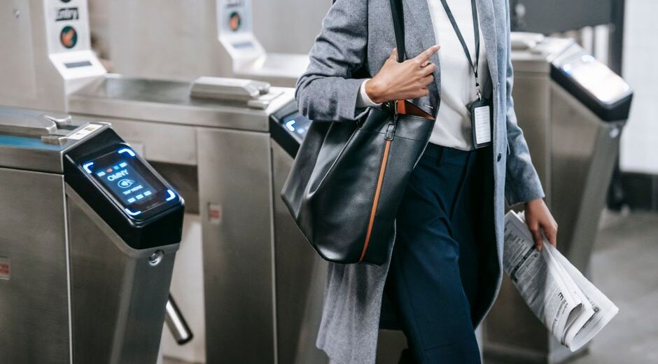 A person with a modern, structured bag navigating a city street, suitable for work or travel.