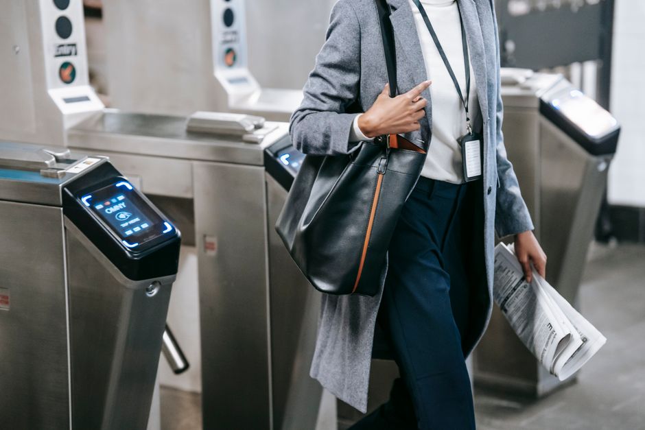 A person with a modern, structured bag navigating a city street, suitable for work or travel.