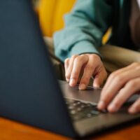 A person at a laptop comparing product specifications and prices from multiple online retailers, highlighting the decision-making process for useful everyday products.