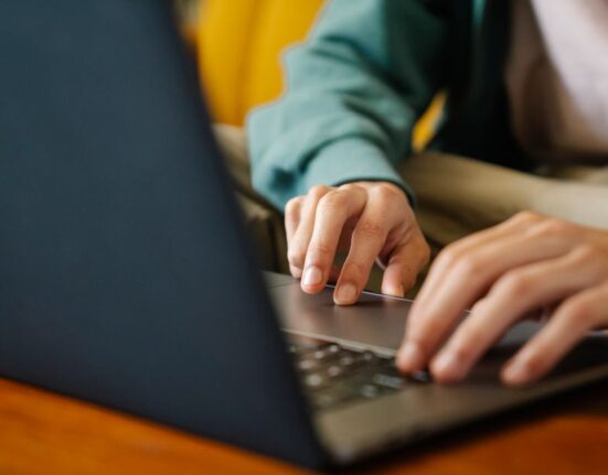 A person at a laptop comparing product specifications and prices from multiple online retailers, highlighting the decision-making process for useful everyday products.