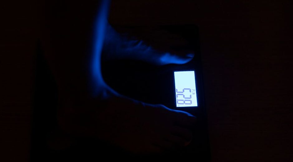 A person using a ruler and paper to measure their foot length at home, illustrating how to get accurate sizing for online shoe purchases.