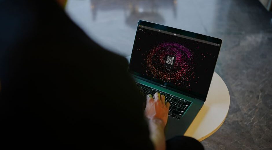 A frustrated person staring at a laptop screen showing a buffering video, illustrating slow VPN speed.