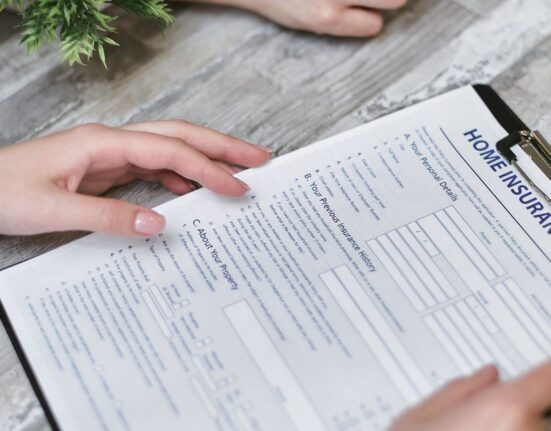 A person studying a detailed privacy policy document on a tablet with a cup of coffee nearby, emphasizing careful review.
