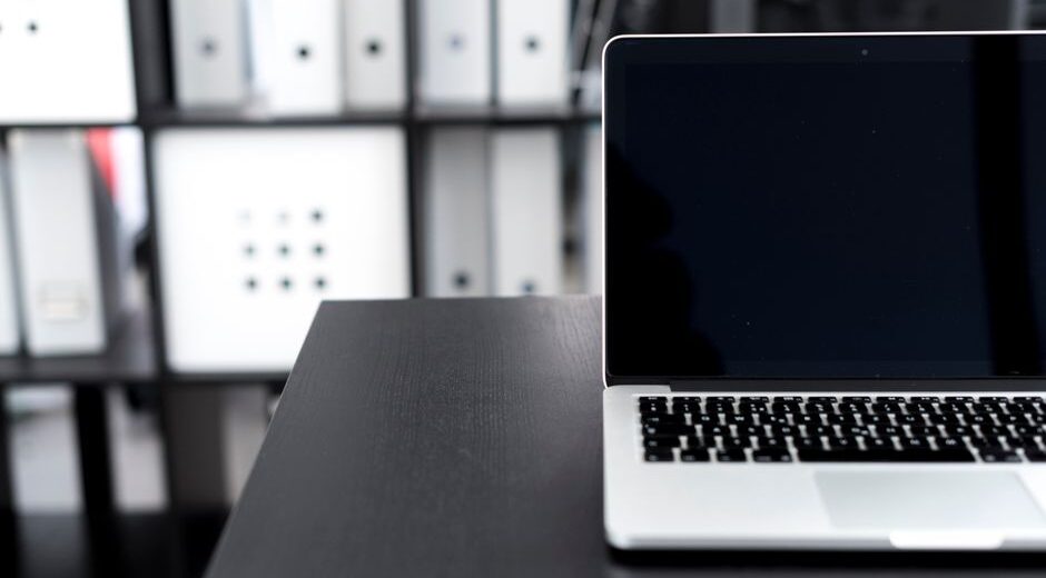 A person's hands meticulously organizing and cleaning digital files on a laptop screen, symbolizing data preparation.