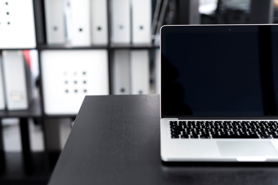 A person's hands meticulously organizing and cleaning digital files on a laptop screen, symbolizing data preparation.