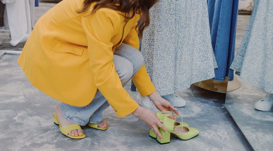 A person in a shoe store trying on a pair of modern, breathable mesh walking shoes, emphasizing comfort and support.