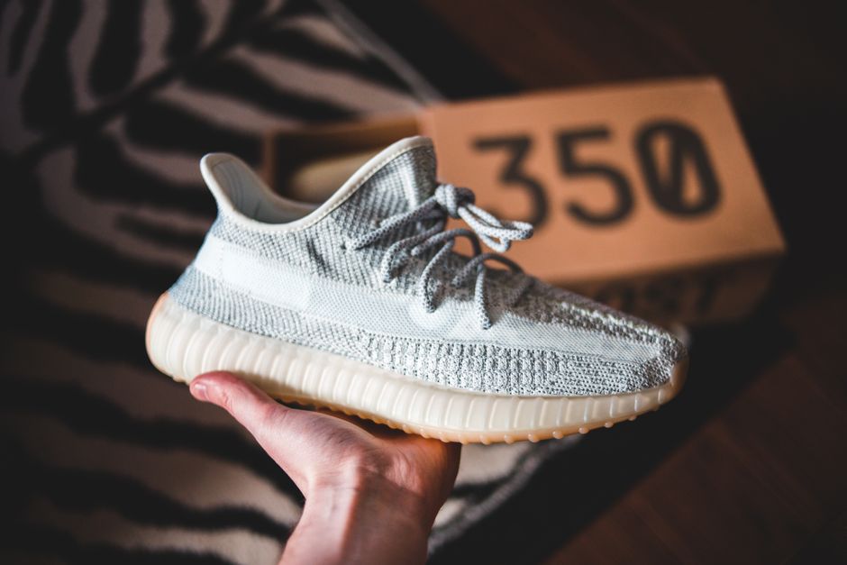 A person wearing new, comfortable footwear walking around their living room, testing the fit.