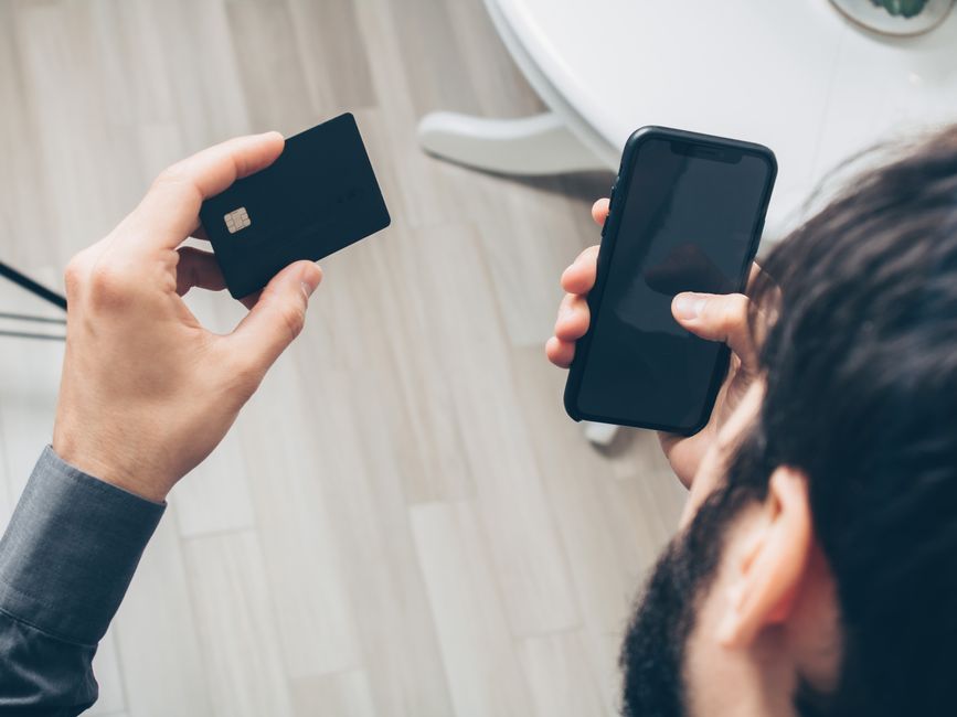 A close-up shot of a smartphone displaying a secure payment gateway with credit card icons, emphasizing the importance of protected online transactions.