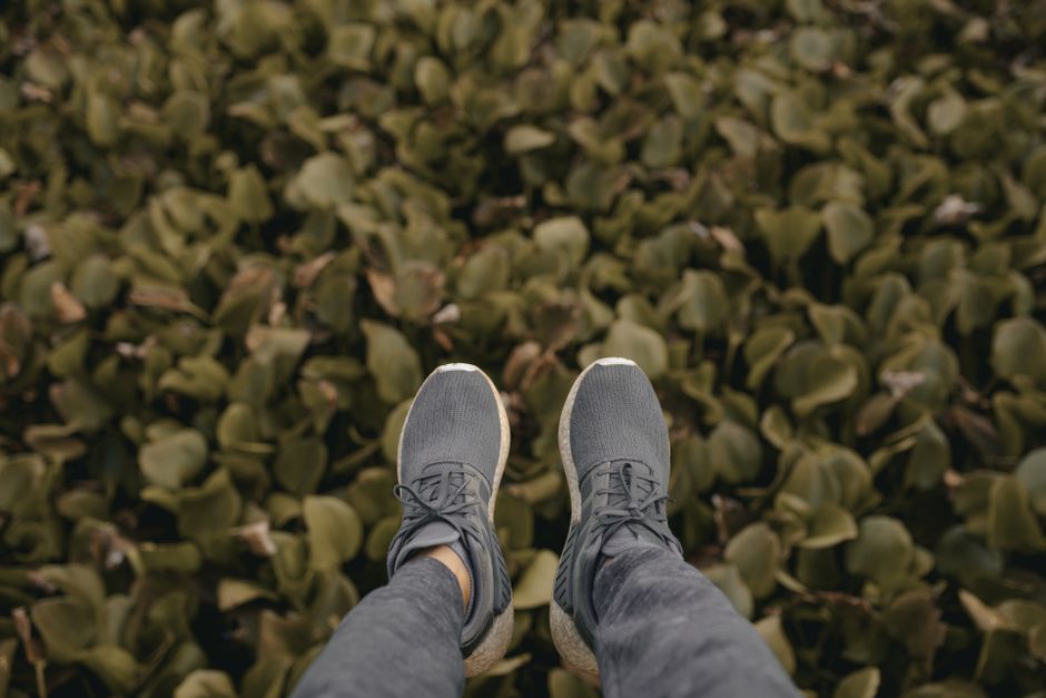 An array of diverse, comfortable walking shoes and boots laid out, showcasing different styles suitable for travel and daily wear.