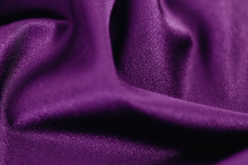 Close-up of Tencel fabric in a light color, showing its soft texture and subtle sheen, highlighting its quality as a breathable material.