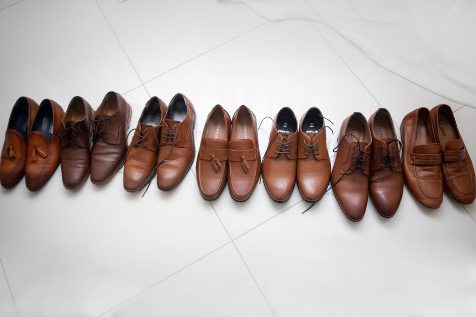 An organized display of various comfortable office shoe styles for men and women, including flats, loafers, and supportive boots.