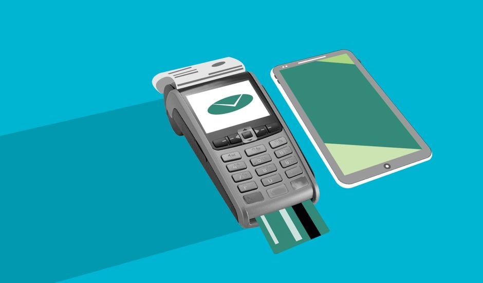 A hand holding a smartphone displaying an online transaction, with various credit cards and debit cards fanned out on a table, emphasizing payment safety and choices.