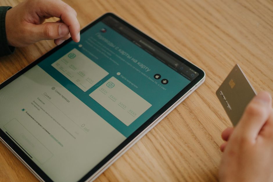 A tablet displaying secure payment icons like credit cards and PayPal, contrasted with less secure options like wire transfers.