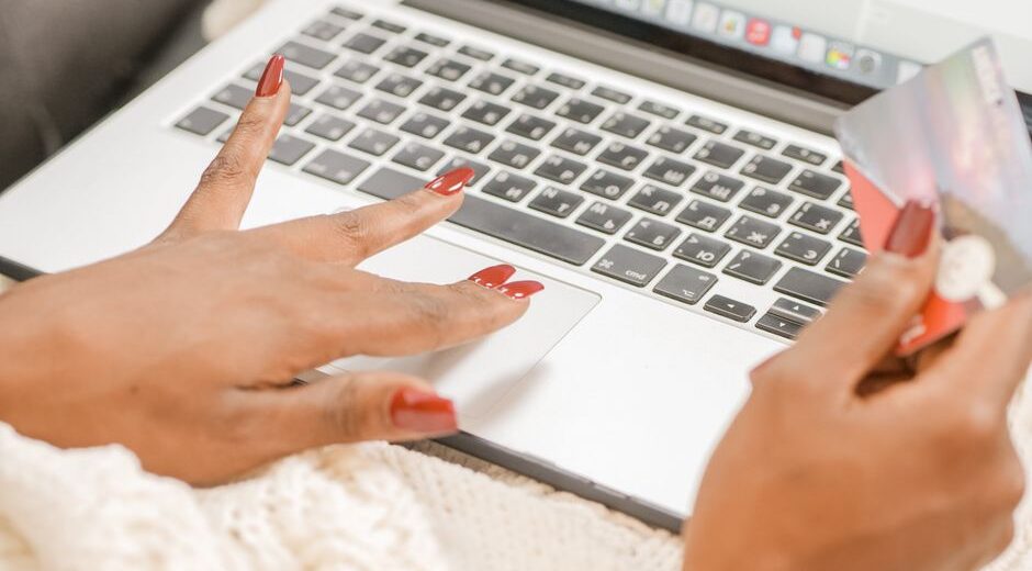 A woman meticulously checking a laptop screen for website security indicators like HTTPS and the padlock icon, reflecting careful online shopping.