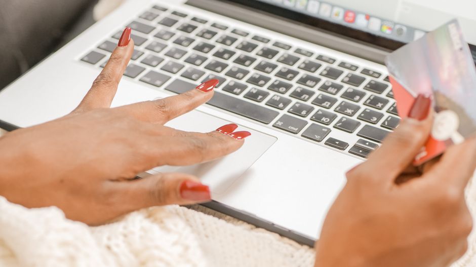 A woman meticulously checking a laptop screen for website security indicators like HTTPS and the padlock icon, reflecting careful online shopping.