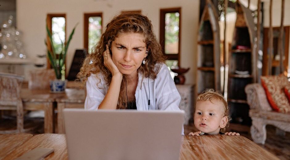 A woman with a concerned expression scrutinizing a laptop screen, showing a dubious online deal.