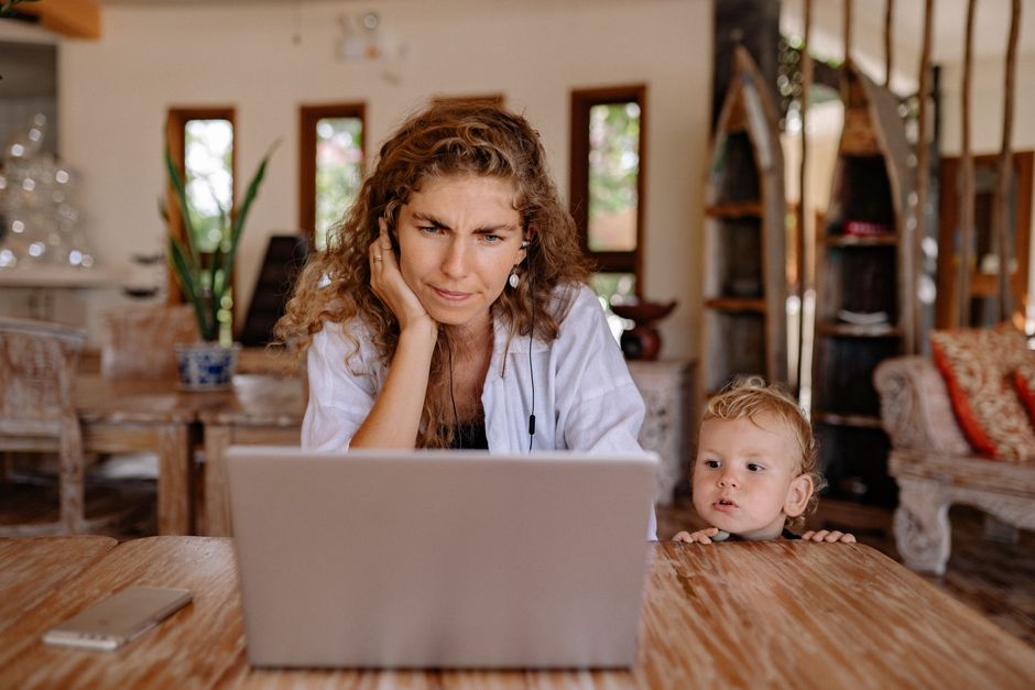 A woman with a concerned expression scrutinizing a laptop screen, showing a dubious online deal.
