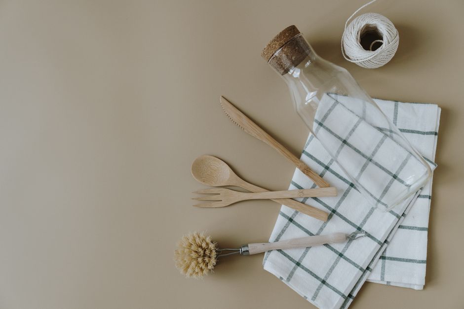 A collection of eco-friendly kitchen essentials like beeswax wraps, reusable containers, and bamboo utensils.